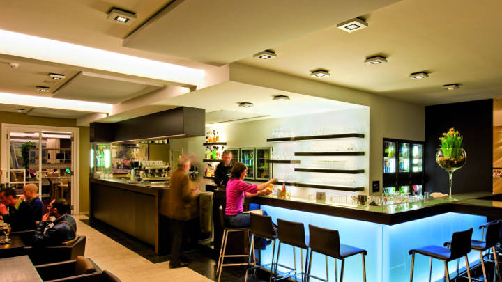 Reception at Ariane Hotel, Belgium lit by Philips hospitality lighting