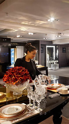 Woman looking at products lit by Philips retail lighting systems 